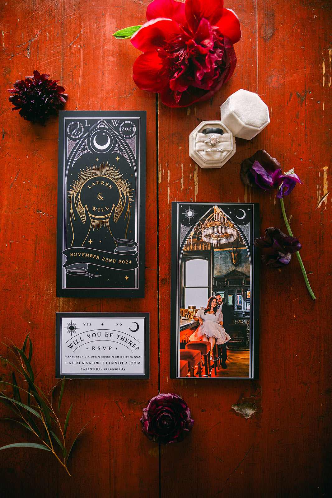 Celestial luxury UK wedding stationery set with foil accents, hexagonal ring box, florals, and a vintage couple photo on rustic wood.