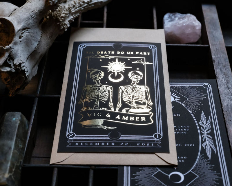 Gothic 'Til Death Do Us Part' foiled save the date card with skeleton design and gold detailing.